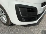 a close up of the front of a white car