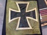 a black and gold cross on a piece of cloth