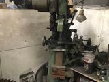 a machine that is sitting in a room with a large saw