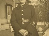 a black and white photo of a woman in a military uniform