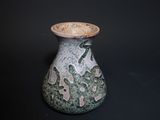 a small vase with a green and white design on it