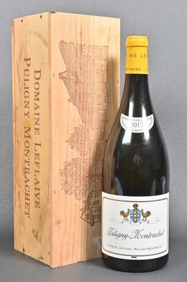 a bottle of wine sitting next to a wooden box