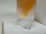 a glass vase that is sitting on a white table