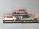 two toy cars are in a clear box on a white surface