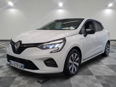 a white car is parked on a checkered floor in a garage