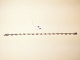 a kite that is flying in the sky with a string attached to it