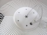 a white fan with a clock on it sitting on a table