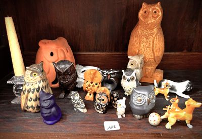 many figurines of animals on a shelf in a room