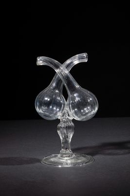 two clear glass vases sitting on top of a black table