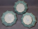 three blue and white plates sitting on top of a table