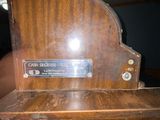 a wooden bench with a plaque on it in a room