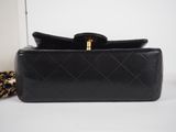a black purse with a chain hanging from it