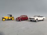 three toy cars sitting next to each other on a table