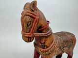 a small wooden horse with a rope around its neck