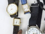 many different types of watches on a white surface