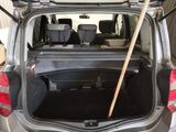 the trunk of a car with a broom sticking out of it ' s trunk