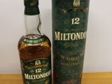 a bottle of whisky sitting next to a cardboard box on a table