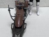 a toy figure of a stormtrooper standing next to a toy motorcycle