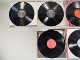 three black vinyl records sitting on top of a white surface