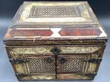 an old wooden box with a decorative design on the inside