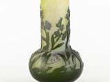 a green vase with a design on it on a white background