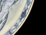 a blue and white plate with a picture of a cat on it