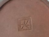 a close up of a brown vase on a table
