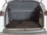 the back of a car with its trunk open and the seat folded down