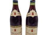 two bottles of wine are sitting next to each other on a white surface