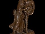bronze statue of a man and a woman holding a shield and shield