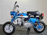 a small blue motorcycle that is parked in a room