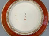 a close up of a red and white vase