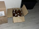 two boxes of beer sitting on the floor next to each other