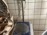 a large metal bowl sitting on a table in a kitchen