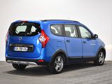the rear end of a blue small car parked in a room