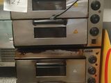 three ovens stacked on top of each other in a kitchen