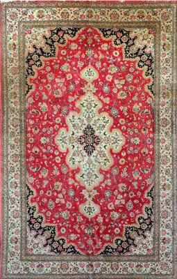 a red and black rug with a medallion design on it