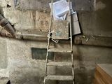 a ladder that is leaning against a wall in a room