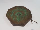 a small wooden box with a green design on it