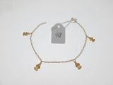 a close up of a gold bracelet with a tag on it