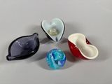 three different colored glass bowls sitting next to each other on a table