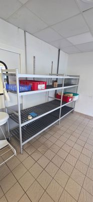 a room with shelves and a chair in it