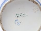 a close up of a blue and white vase with writing on it