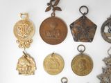 a lot of medals that are on a white surface