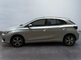 the silver car is parked on the concrete floor in the room