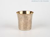 a silver cup that is sitting on a table