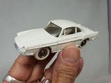 a person holding a toy car in their hand