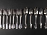 six spoons and six forks are lined up on a black surface