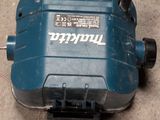 a blue electric device that is on the ground