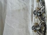 an image of a close up of a white shirt with a black and gold design